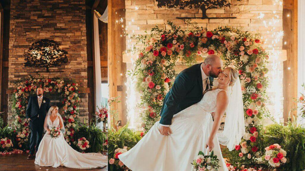 Photos of a bride and groom in front of the stone fireplace at Oakhaven. Photos show beautiful flowers, ferns, and indoor sparklers on either side of the fireplace.